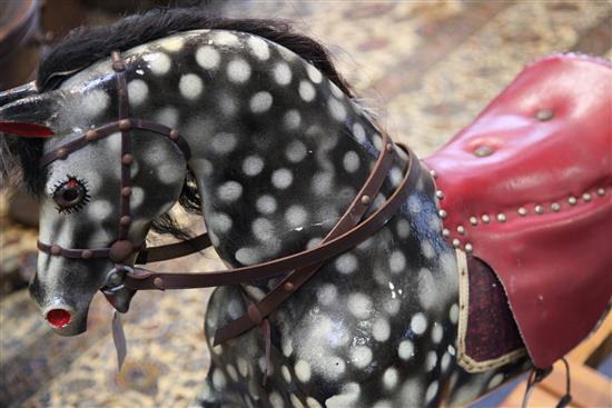 A black and grey painted rocking horse, overall length 6ft 11in.